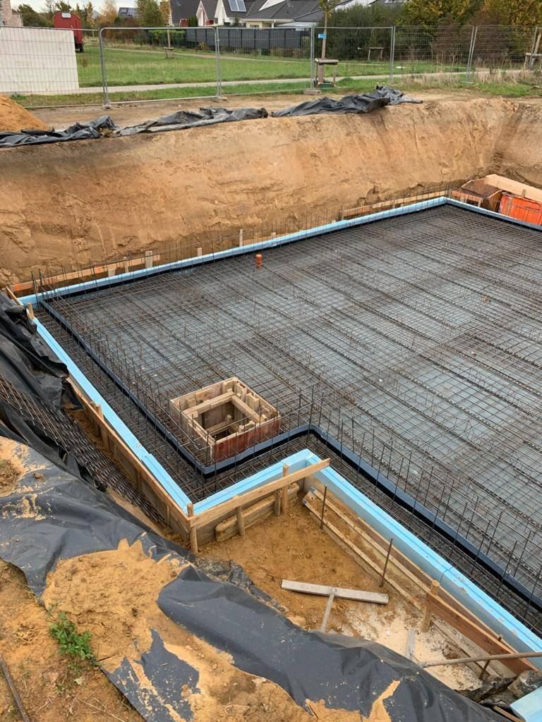 Bodenplatte mit blauer Perimeterdämmung entlang der Gründung
